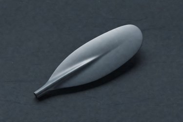 Render of a carbon fiber composite kayak paddle with drip rings on slate